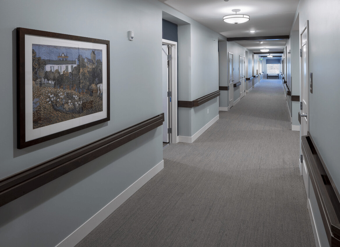 Hallway in assisted living wing with framed art