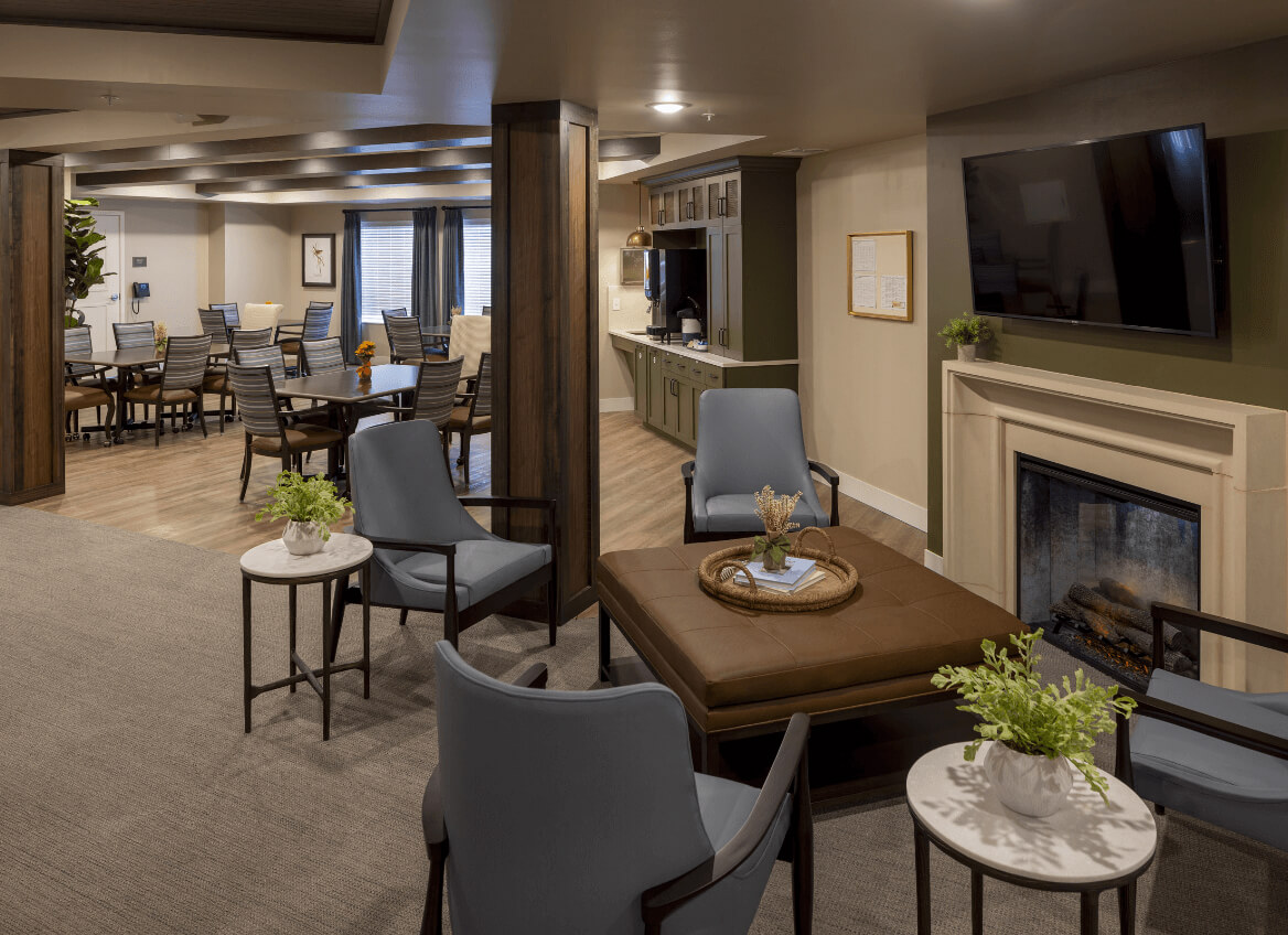 Lounge area with fireplace, TV, and chairs