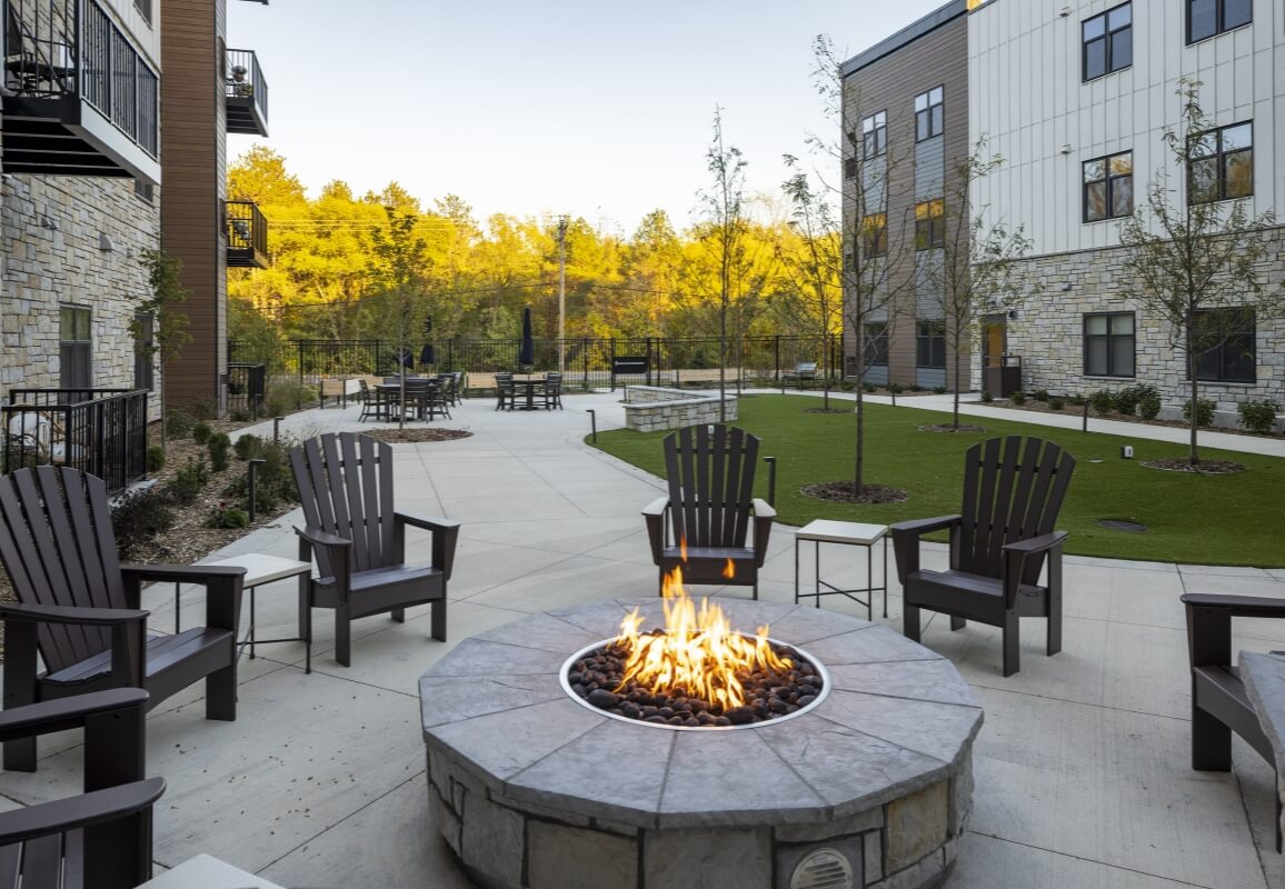 Outdoor firepit surrounded by chairs in the courtyard