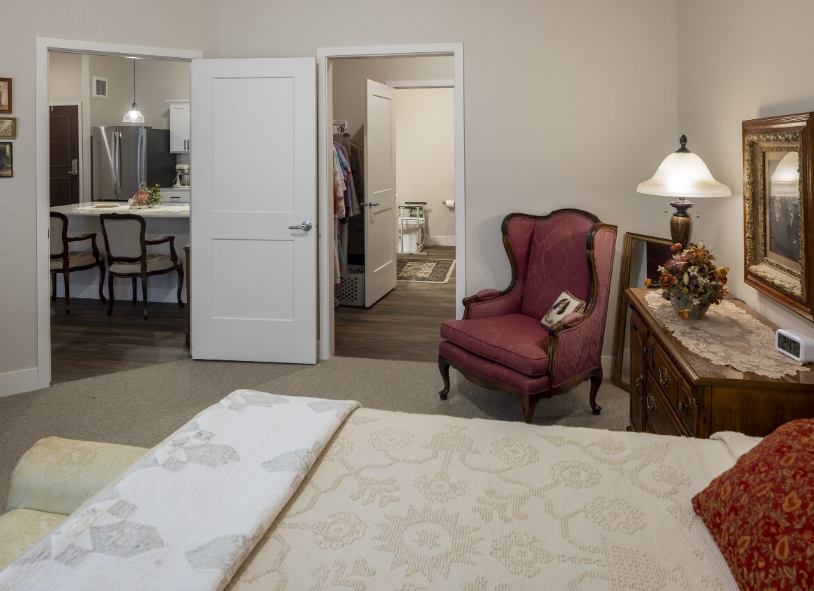 Bedroom with view into kitchen and bathroom