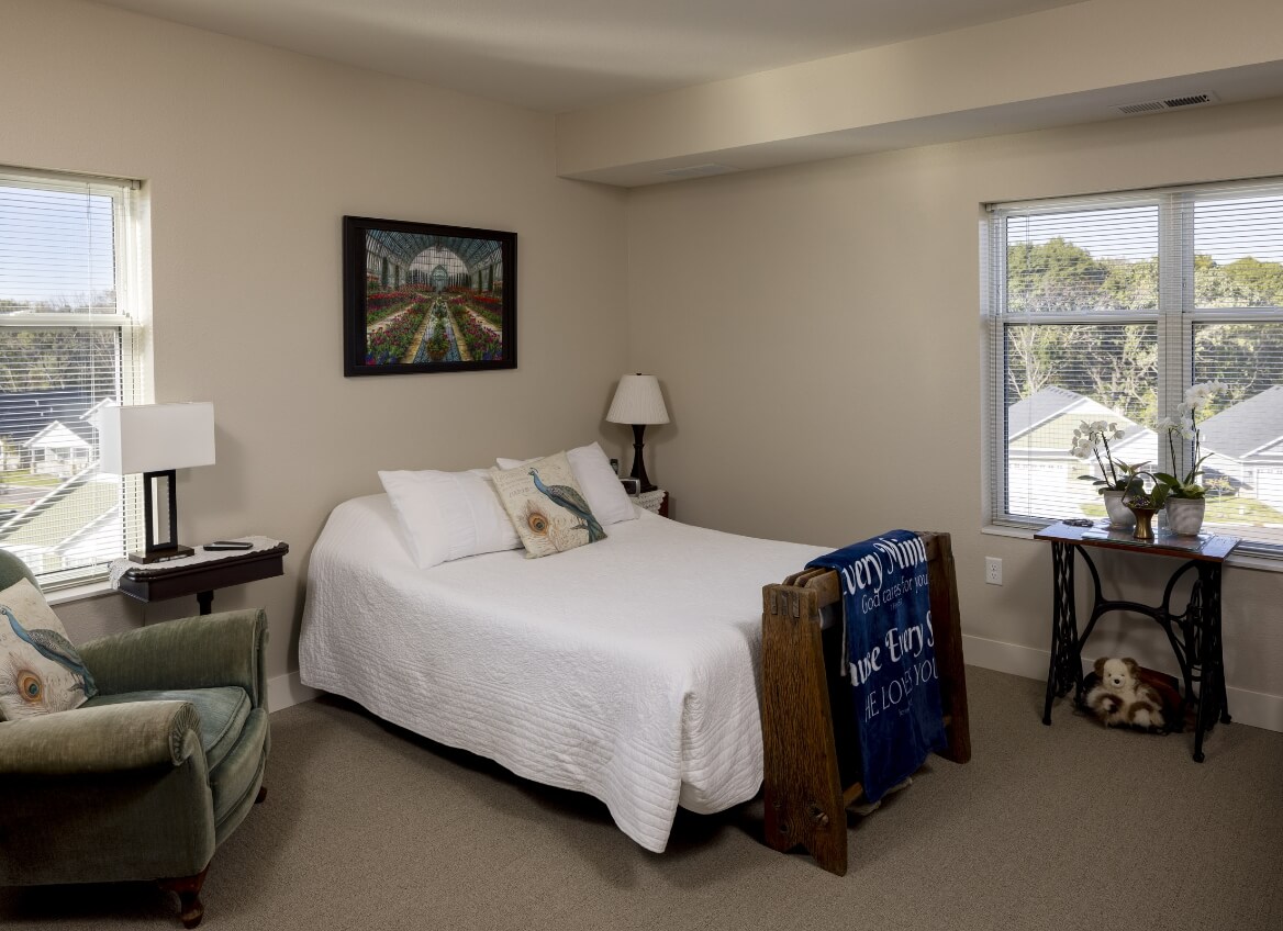 Bright bedroom with window and reading chair