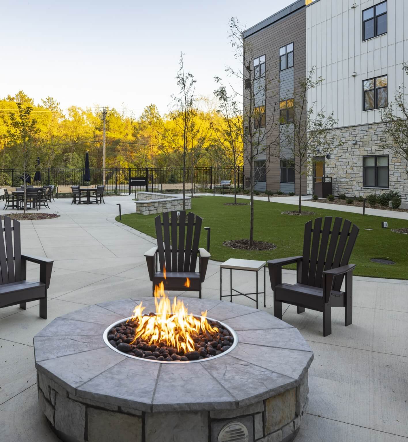 Outdoor firepit with Adirondack chairs at Lyngblomsten campus
