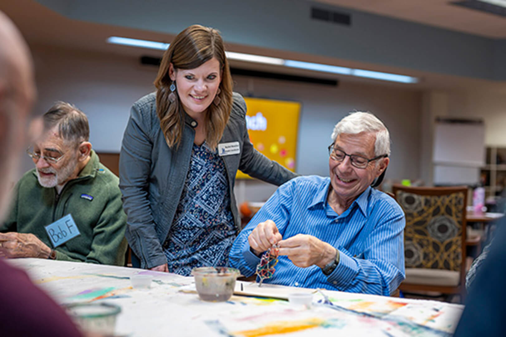 A staff member engaging with older adults during a memory care activity at Lyngblomsten’s The Gathering program.
