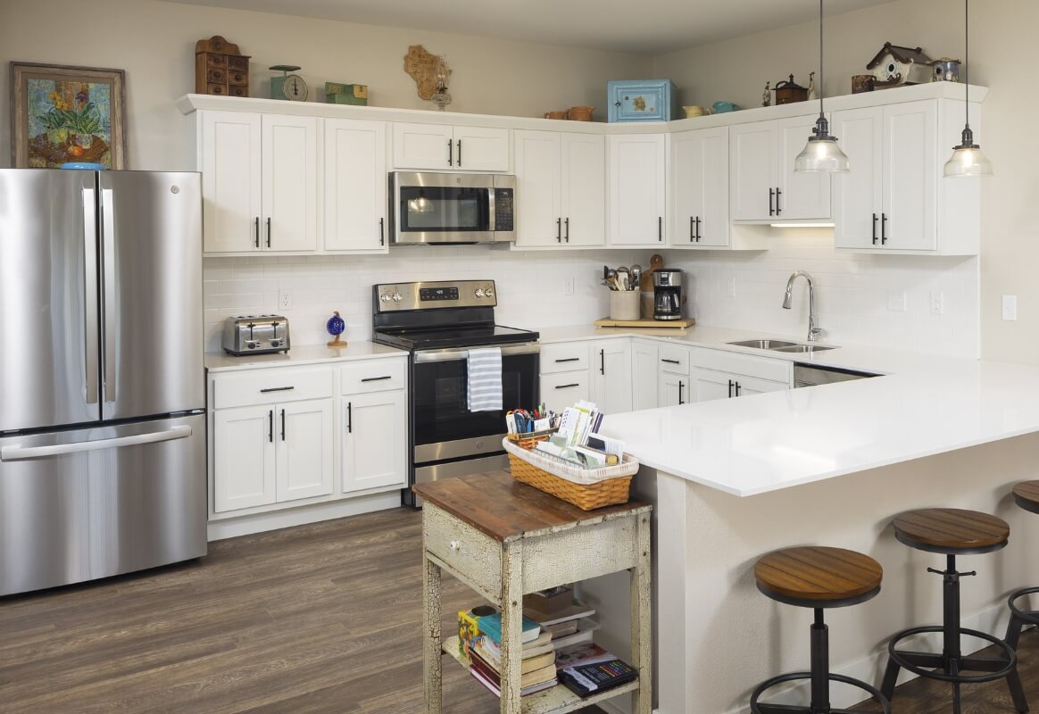 Kitchen Modern apartment kitchen with white cabinets and island seating