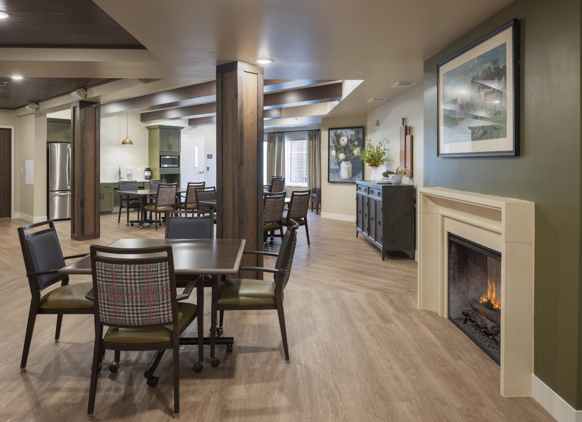 Memory Care dining area with fireplace and community tables