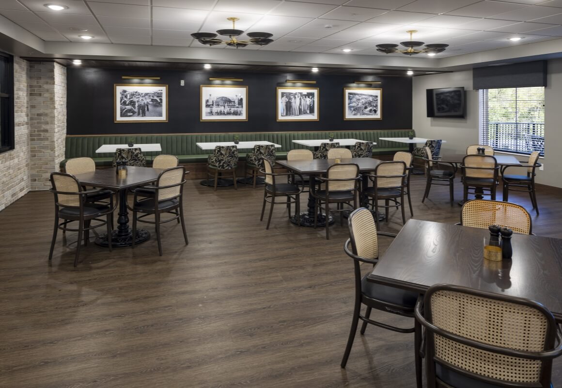 Dining area with tables, booth seating, and framed photos in Mikelson's Tavern.