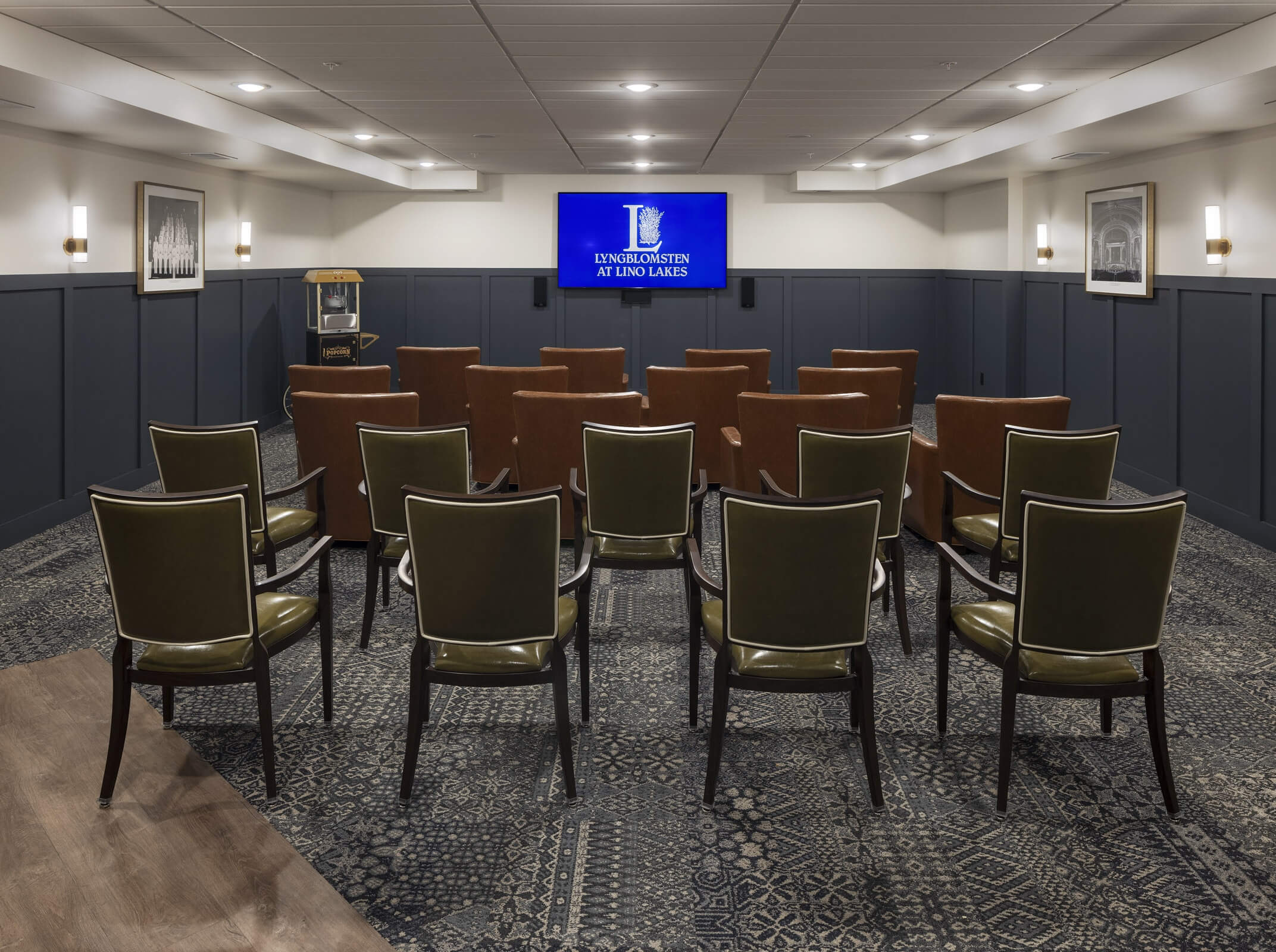Movie theater room with rows of chairs facing a screen
