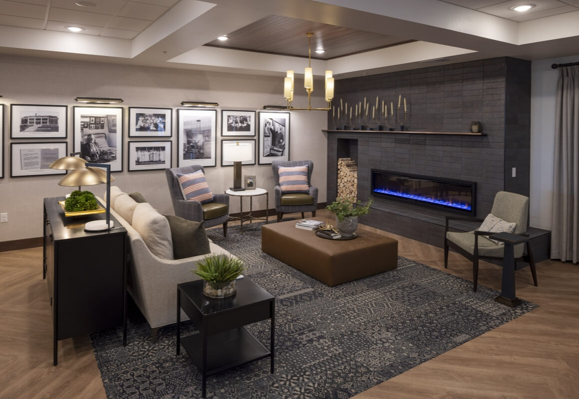 Lounge with seating area, fireplace, and historic black-and-white photos