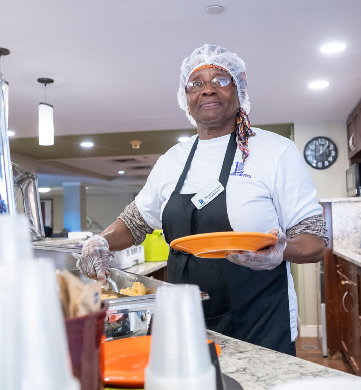 Lyngblomsten Care Center employee plates fresh food for residents to enjoy.