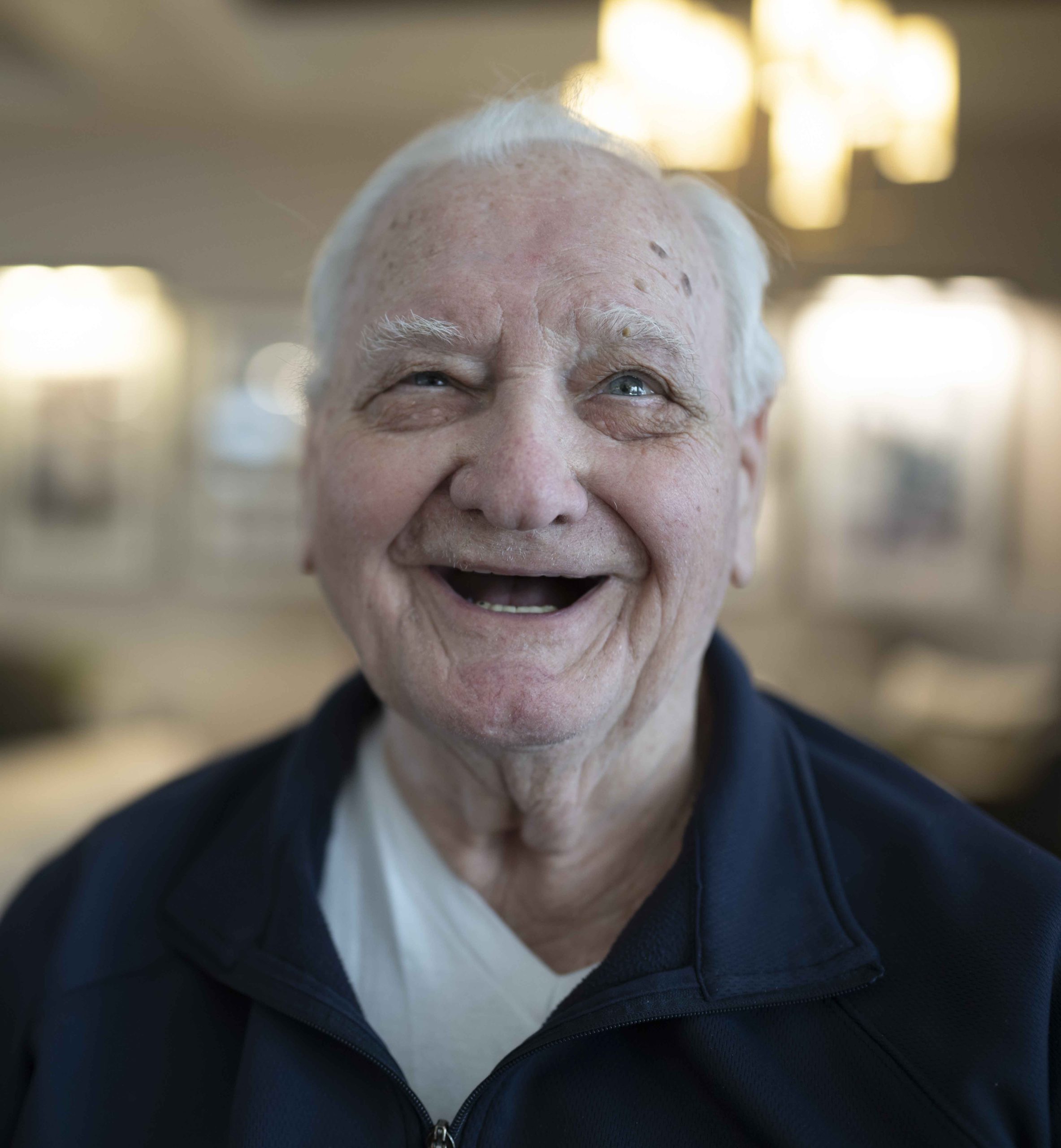 A gentleman is sitting in Sophia's at the Lyngblomsten on the Lino Lakes campus.