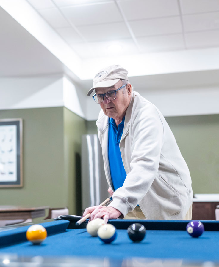 Lyngblomsten at Lino Lakes resident plays pool in the Gameroom.
