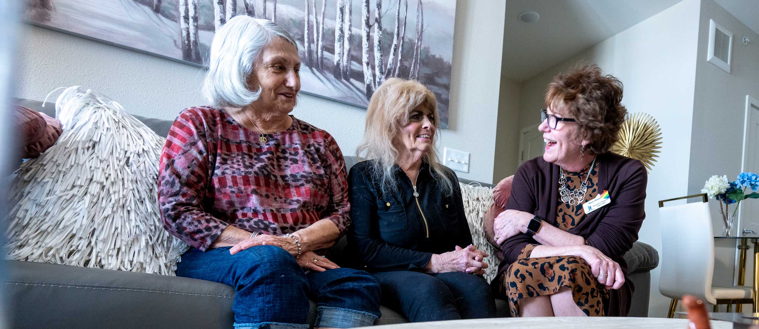 A friend visits her friend in her Assisted Living apartment, along with the Executive Director, on the Lino Lakes campus.