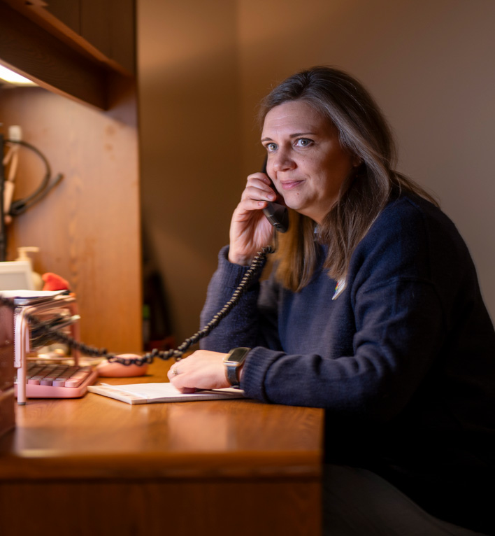 Lyngblomsten Community Services staff talking on the phone to a caregiver.