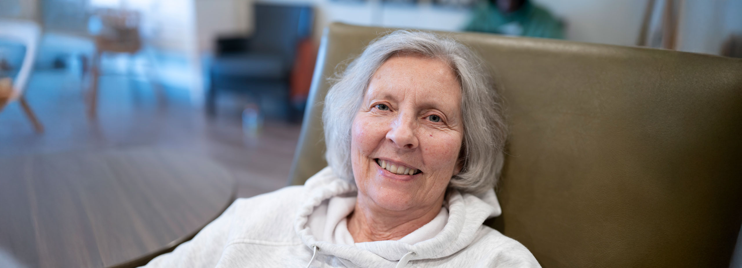A Lyngblomsten at Lino Lakes Memory Care resident smiling into the camera.