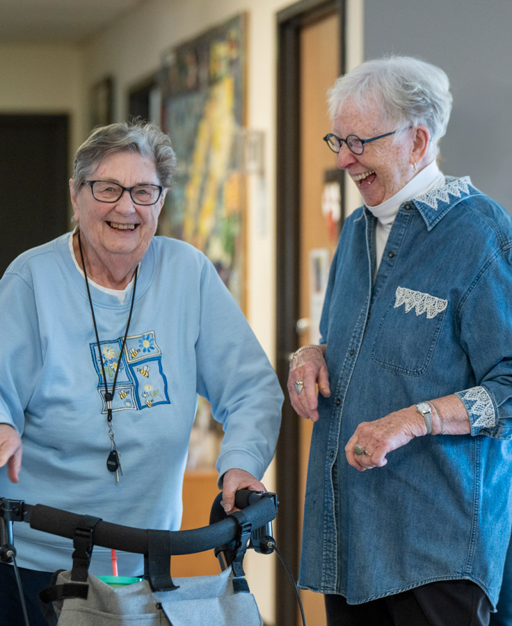 Two residents laughing in the Lyngblomsten Apartments.