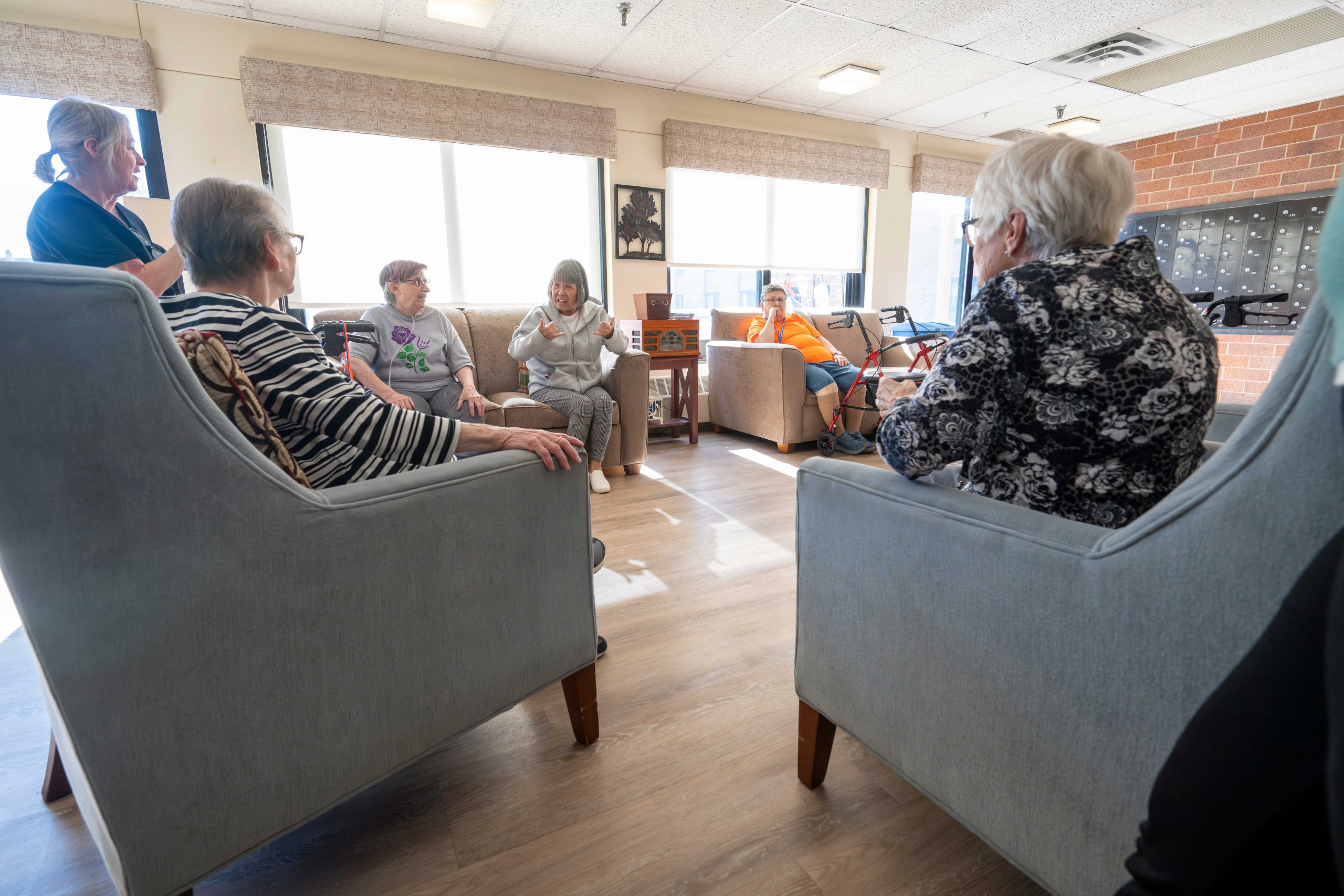 Residents that are a part of the deaf community gather in the Lyngblomsten Apartments Lobby to socialize.