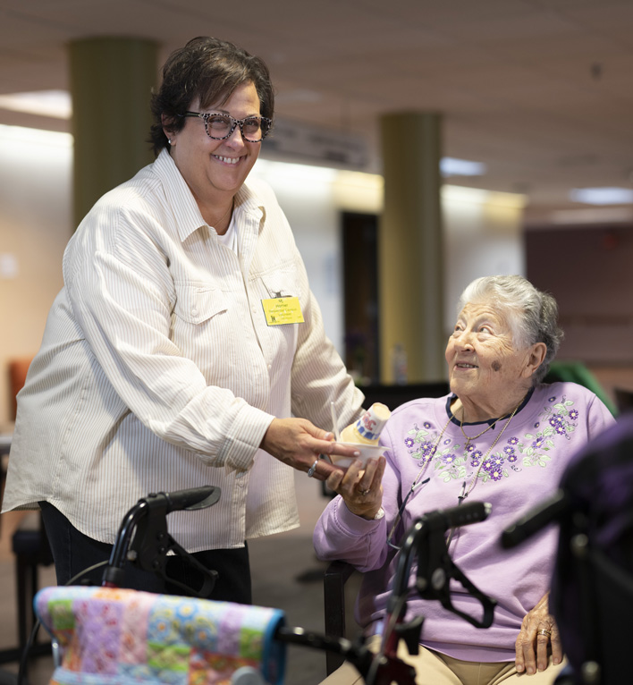 A Lyngblomsten Volunteer Brings Her Mother, a Resident, an Ice Cream Cone from Anna's cafe and gifts