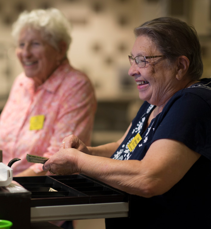 A Volunteer Checks out a Customer at Anna's cafe and gifts
