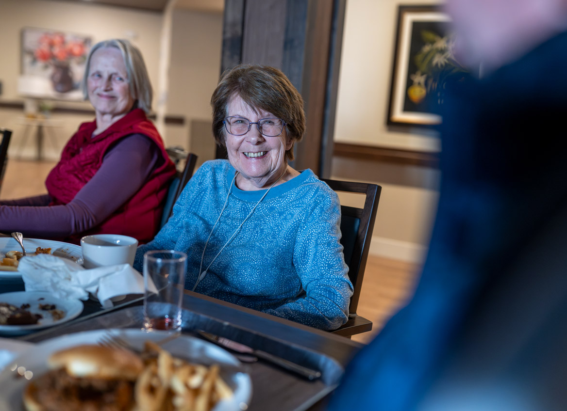 Assisted Living Residents Sit Down to Enjoy a Meal in the Community Dining Room