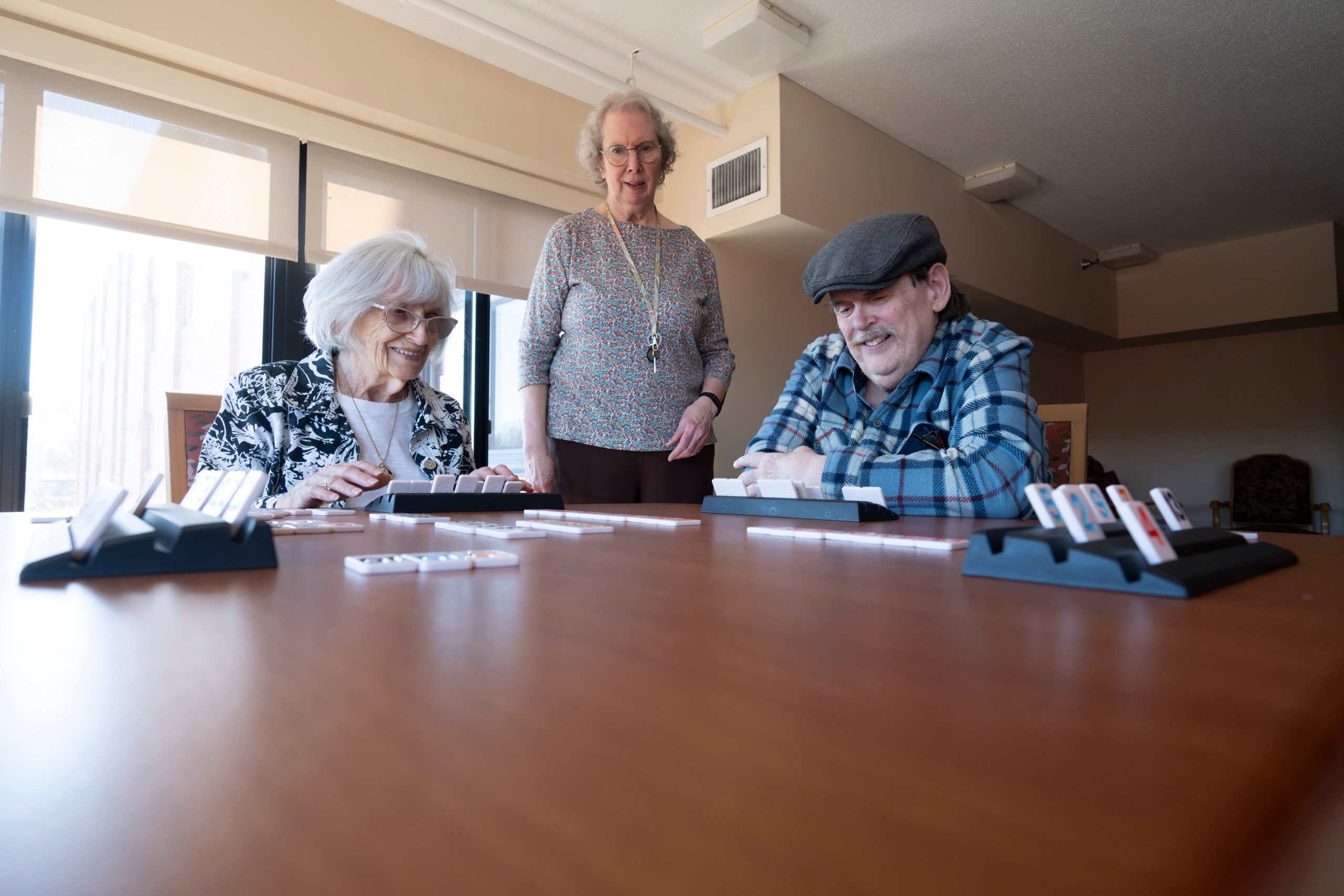 Lyngblomsten Apartment Residents Gather in a Lounge Area to Play Dominos
