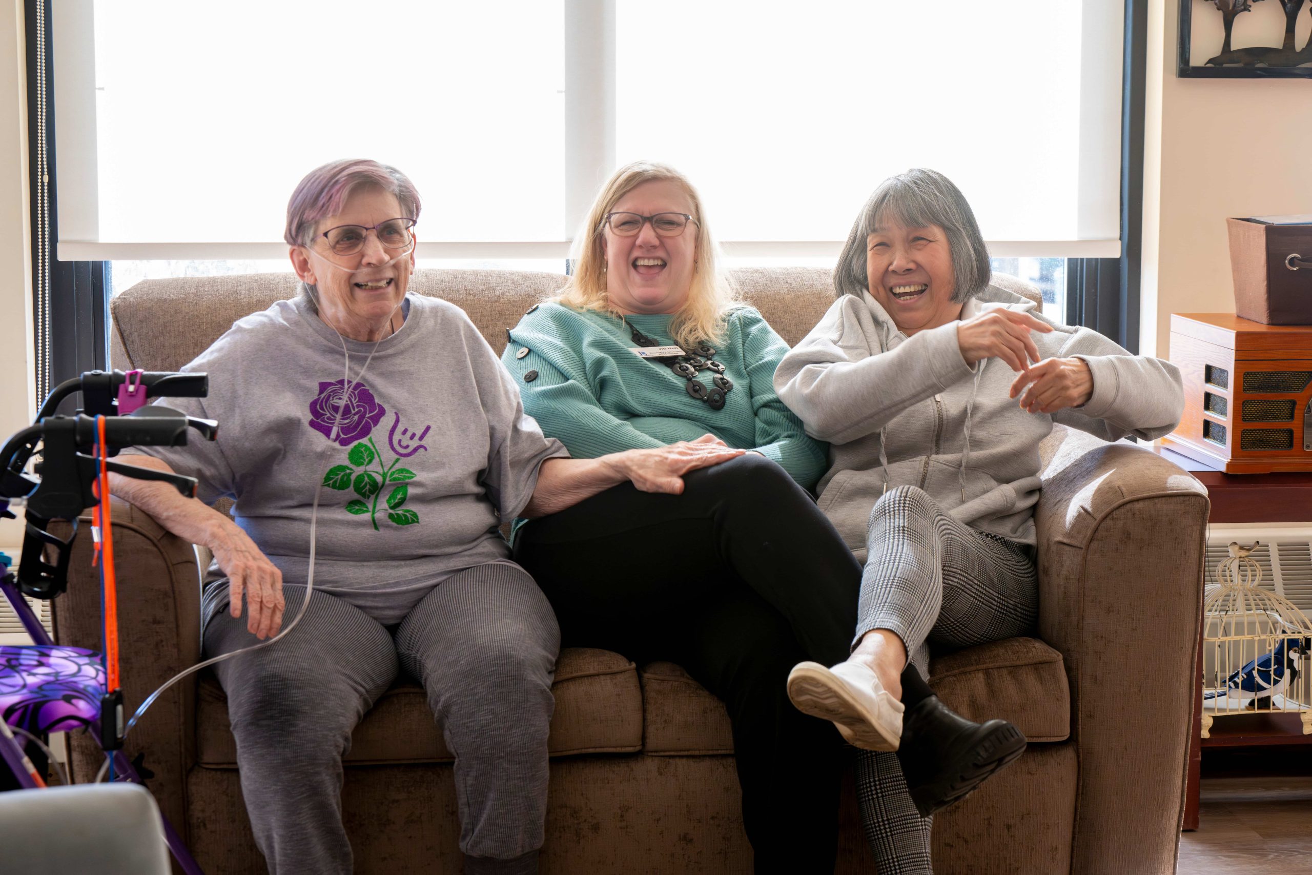 Residents Laughing on the Couch with the Lyngblomsten Apartments Executive Director