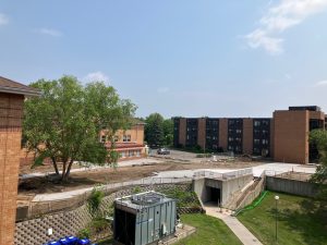 A view of the courtyard at Lyngblomsten's Como Park campus with mostly finished concrete sidewalks laid out in the dirt.