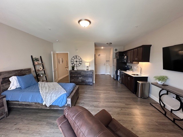 Lino Lakes Respite Care: bed, recliner, living room area, and kitchen